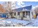 Tan house exterior with snowy yard at 2101 S Lafayette St, Denver, CO 80210
