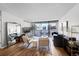 Living room with hardwood floors, city views and a stylish mid-century modern furniture arrangement at 1020 15Th St # 27E, Denver, CO 80202