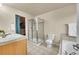 Bright bathroom featuring a glass shower, soaking tub, and a walk-in closet at 22801 E Briarwood Pl, Aurora, CO 80016