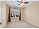 Cozy bedroom with neutral walls, window view, and ceiling fan at 22801 E Briarwood Pl, Aurora, CO 80016