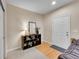 Entryway featuring hardwood floors, console table, and a bright white front door at 22801 E Briarwood Pl, Aurora, CO 80016