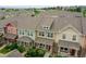 Townhome community showcasing colorful facades, well-maintained landscaping, and a desirable neighborhood setting at 22801 E Briarwood Pl, Aurora, CO 80016