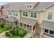 Charming townhome with a covered front porch, colorful exterior, and manicured landscaping at 22801 E Briarwood Pl, Aurora, CO 80016