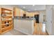 Open kitchen featuring wood cabinets, modern appliances, and hardwood floors at 22801 E Briarwood Pl, Aurora, CO 80016