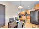 Stylish kitchen featuring wood cabinets, granite countertops and a modern island at 22801 E Briarwood Pl, Aurora, CO 80016