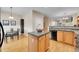 Bright eat-in kitchen featuring wood cabinetry, stone countertops, and stainless steel appliances at 22801 E Briarwood Pl, Aurora, CO 80016