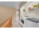 Upstairs laundry room with washer, dryer, and shelving at 22801 E Briarwood Pl, Aurora, CO 80016