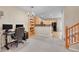 Open-concept living space with desk area, hardwood floors, and stainless steel appliances at 22801 E Briarwood Pl, Aurora, CO 80016