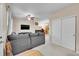 Spacious living room with large gray sectional, ceiling fan, and access to other rooms at 22801 E Briarwood Pl, Aurora, CO 80016