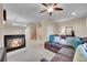 Open living room with fireplace, comfortable seating, and a view of the staircase at 22801 E Briarwood Pl, Aurora, CO 80016