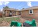 Backyard featuring a grill, green chairs, and a patio, perfect for outdoor cooking and relaxation at 3667 Hudson St, Denver, CO 80207