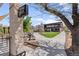 Landscaped courtyard with a wine bar sign pointing to a building featuring outdoor seating at 3667 Hudson St, Denver, CO 80207