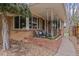 A cozy, covered front porch with chairs and brick planters, perfect for relaxing outside at 3667 Hudson St, Denver, CO 80207