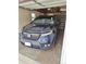 View of a car parked inside the home's garage at 3667 Hudson St, Denver, CO 80207