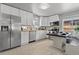 Updated kitchen features stainless steel appliances, white cabinetry, butcher block countertop, and breakfast bar at 3667 Hudson St, Denver, CO 80207