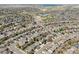 An aerial view showcasing a community with well-maintained homes and a lake in the background at 9763 Cove Creek Dr, Highlands Ranch, CO 80129
