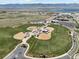 Aerial view of multiple baseball fields and community amenities with scenic mountain views at 9763 Cove Creek Dr, Highlands Ranch, CO 80129