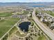 Aerial view showcasing the community park featuring a scenic pond and recreational amenities at 9763 Cove Creek Dr, Highlands Ranch, CO 80129