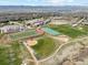 Aerial view showcasing a sports complex with a football field, tennis courts, and baseball field at 9763 Cove Creek Dr, Highlands Ranch, CO 80129