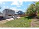 Spacious backyard featuring a well-manicured lawn and a patio with outdoor seating at 9763 Cove Creek Dr, Highlands Ranch, CO 80129