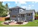 Backyard with patio features an outdoor dining area and seating perfect for entertaining at 9763 Cove Creek Dr, Highlands Ranch, CO 80129