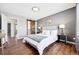 Comfortable bedroom boasts hardwood floors, sliding barn door, and modern decor at 9763 Cove Creek Dr, Highlands Ranch, CO 80129