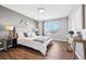 Bedroom features hardwood floors, a large window, and gray walls at 9763 Cove Creek Dr, Highlands Ranch, CO 80129