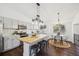 Light and bright kitchen with white cabinets, butcher block island, and eat-in dining at 9763 Cove Creek Dr, Highlands Ranch, CO 80129
