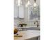 Bright kitchen detail featuring subway tile backsplash, modern faucet, and custom cabinetry at 9763 Cove Creek Dr, Highlands Ranch, CO 80129