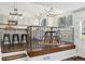 Kitchen with stainless steel appliances, island seating, and a dining area with railing at 9763 Cove Creek Dr, Highlands Ranch, CO 80129