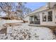 Large backyard with snow and wooden steps at 1441 E 84Th Pl, Denver, CO 80229