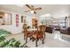 Dining area with a wooden table and chairs, adjacent to living room at 1441 E 84Th Pl, Denver, CO 80229