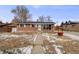 Brick ranch home with solar panels and a walkway at 1441 E 84Th Pl, Denver, CO 80229