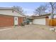 Brick home with attached garage and driveway at 1441 E 84Th Pl, Denver, CO 80229