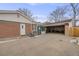 Brick home with attached garage and driveway at 1441 E 84Th Pl, Denver, CO 80229