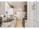 White kitchen cabinets, granite counters, and stainless steel appliances at 1441 E 84Th Pl, Denver, CO 80229