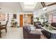 Open living room with skylights and leather furniture at 1441 E 84Th Pl, Denver, CO 80229