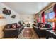 Spacious living room with leather sofas and two lamps at 1441 E 84Th Pl, Denver, CO 80229