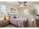 Cozy bedroom features neutral paint and a patterned bedspread at 7770 Owl Creek Cir, Littleton, CO 80125