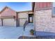 Welcoming front entrance featuring stone accents, a modern door, and well-maintained landscaping at 7770 Owl Creek Cir, Littleton, CO 80125