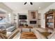 Cozy living room featuring a modern fireplace, custom built-ins, and comfortable seating, perfect for relaxation at 7770 Owl Creek Cir, Littleton, CO 80125