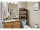 Stylish powder room featuring a granite countertop vanity and decorative shelving at 7770 Owl Creek Cir, Littleton, CO 80125