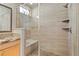 Shower features tile surround, bench seating, and glass door at 7770 Owl Creek Cir, Littleton, CO 80125