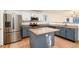 Well-lit kitchen featuring stainless steel appliances and a central island at 5294 S Espana St, Centennial, CO 80015