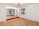 Bright living room showcasing hardwood floors and an open entryway to other spaces at 5294 S Espana St, Centennial, CO 80015