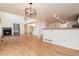 Open floor plan featuring hardwood floors, fireplace, built-ins and access to kitchen at 5294 S Espana St, Centennial, CO 80015