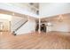 Expansive living space with hardwood floors, high ceilings, a staircase, and an open layout flowing into the kitchen at 5294 S Espana St, Centennial, CO 80015