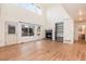 This is a view of a living room with wood floors, a fireplace, and access to a bathroom at 5294 S Espana St, Centennial, CO 80015