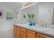 Bright bathroom featuring a double vanity, tub with tile surround, and a large mirror at 2500 Lexington St, Lafayette, CO 80026