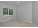 Bedroom features neutral carpet, trim, baseboards, and a window with blinds at 2500 Lexington St, Lafayette, CO 80026